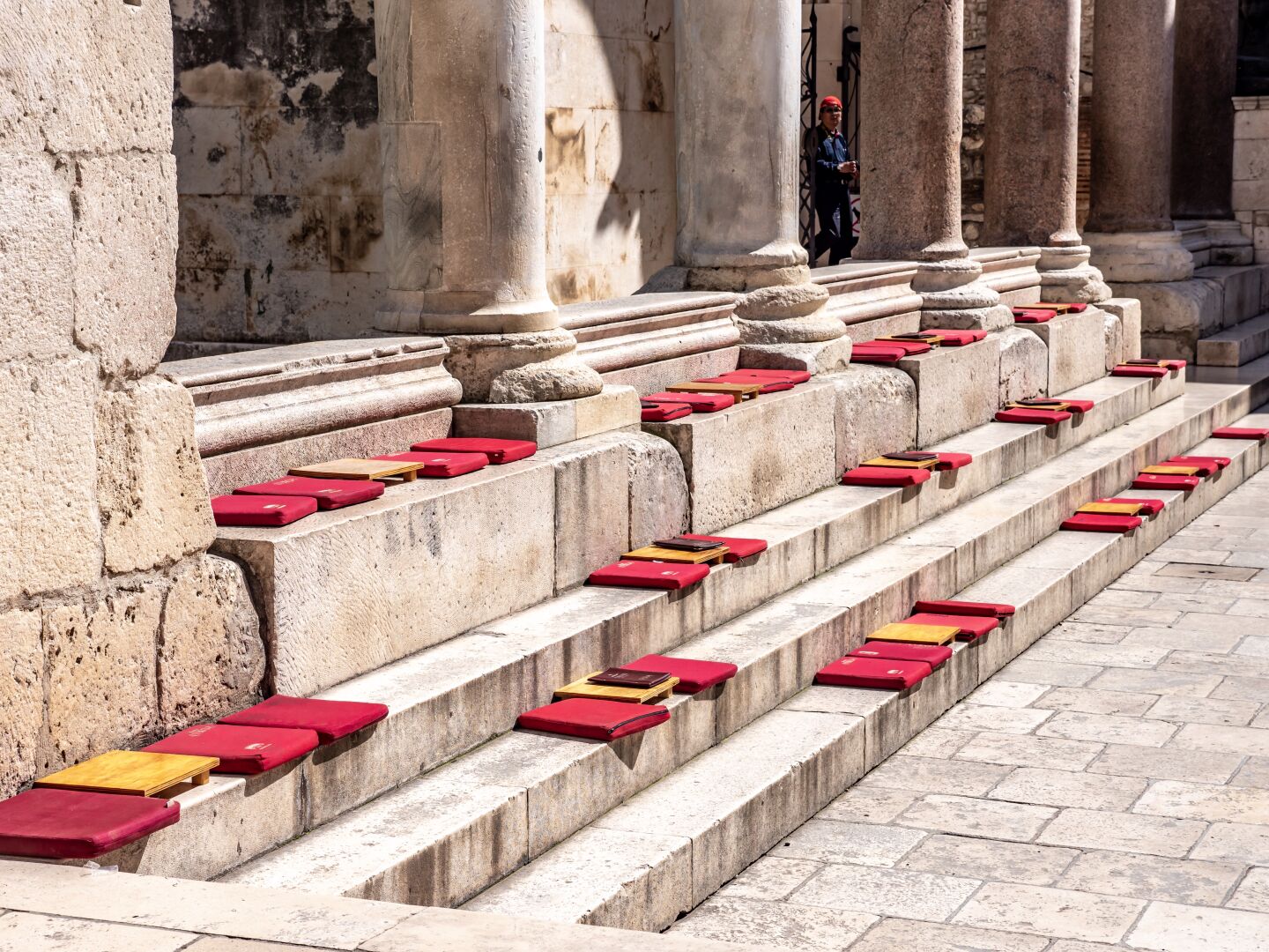 Stone steps have cushions on them to provide a nice reading and sitting place in the sun