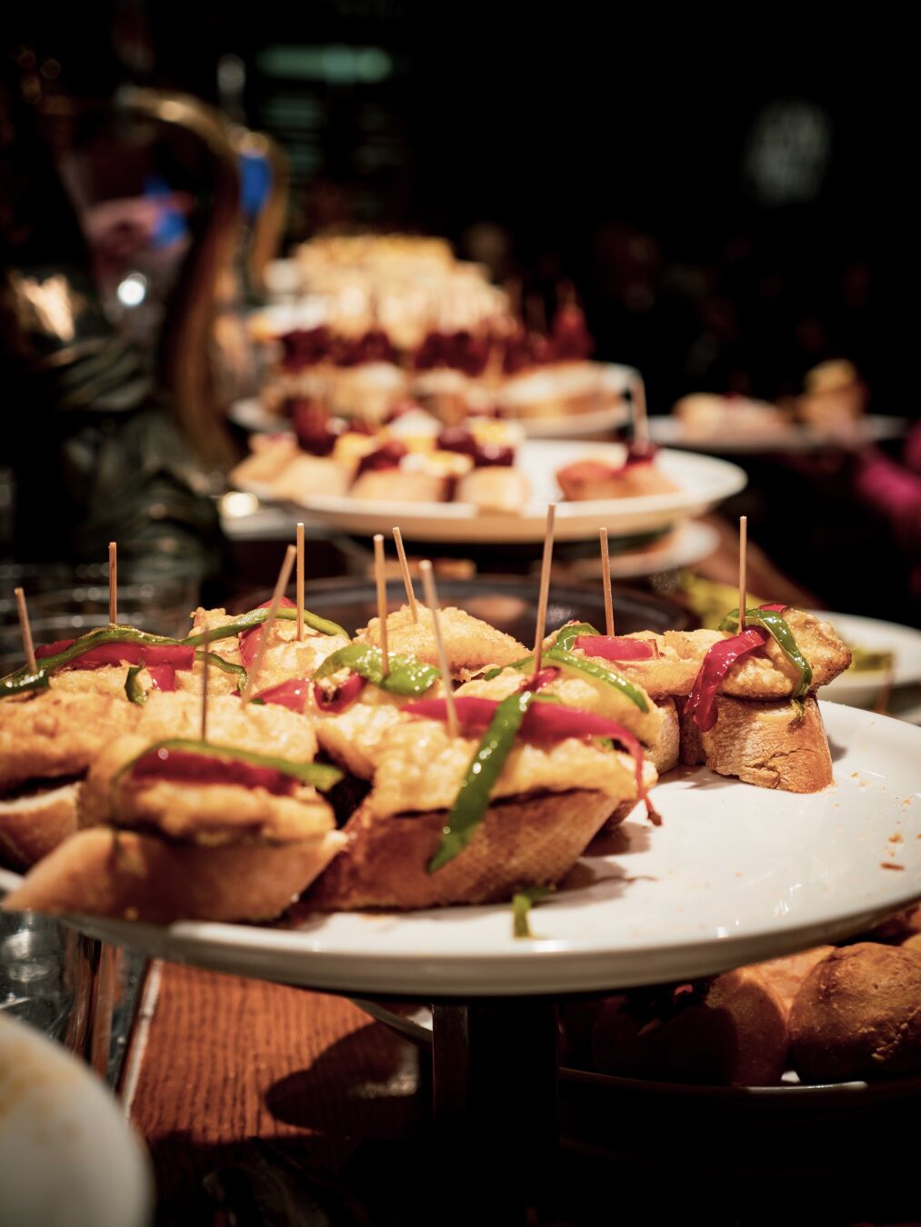 Multiple plates with small snacks on them